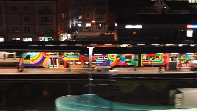 Graffiti-painted train blurred by a long exposure at night.
